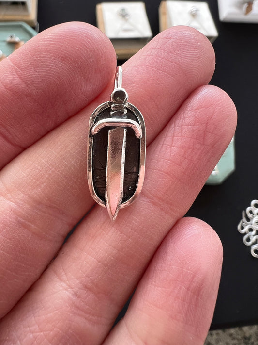 rounded rectangle sword pendant